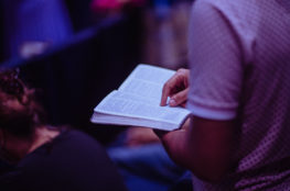Selective focus photo of person holding book